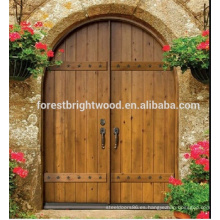 Puerta de entrada de hoja doble arqueada Puerta de entrada de hoja doble maciza Puerta de madera tallada